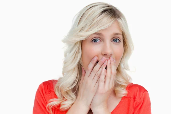Surprised attractive woman placing her hands on her mouth — Stock Photo, Image