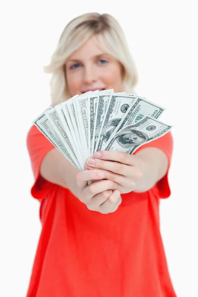 A fan of dollar notes held by a woman — Stock Photo, Image
