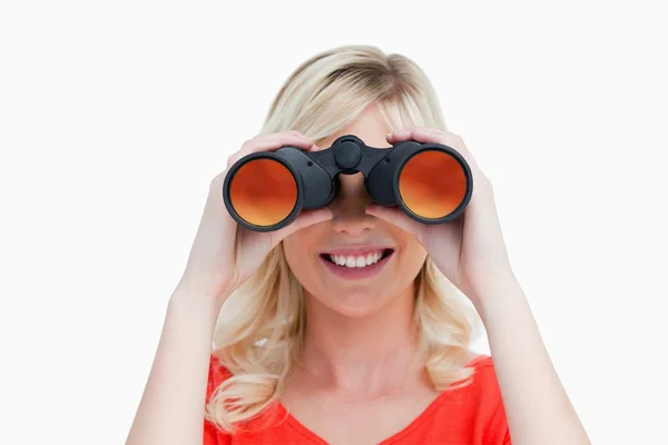 Blonde woman looking through binoculars — Stock Photo, Image