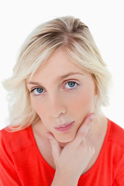 Thoughtful young woman putting her fingers on her chin — Stock Photo, Image