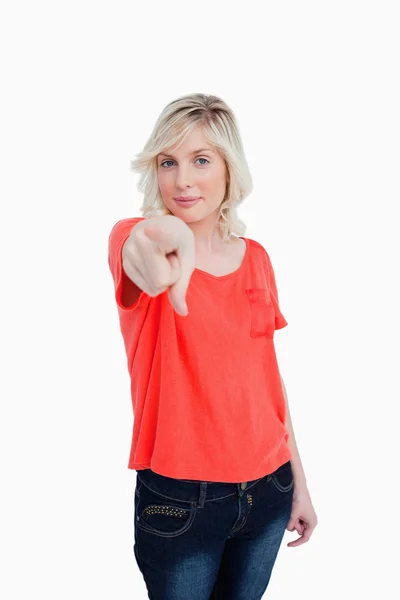 Young woman almost smiling while pointing her finger — Stock Photo, Image