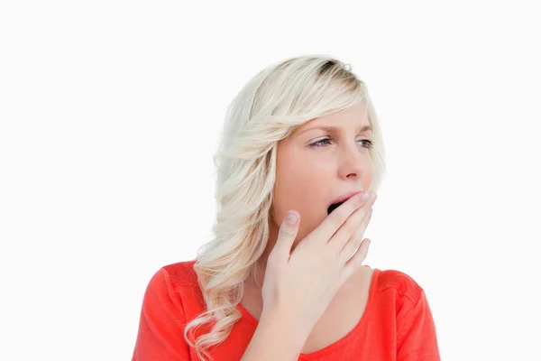 Young blonde woman looking on the side while yawning — Stock Photo, Image