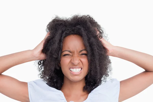 stock image Young angry woman holding her head