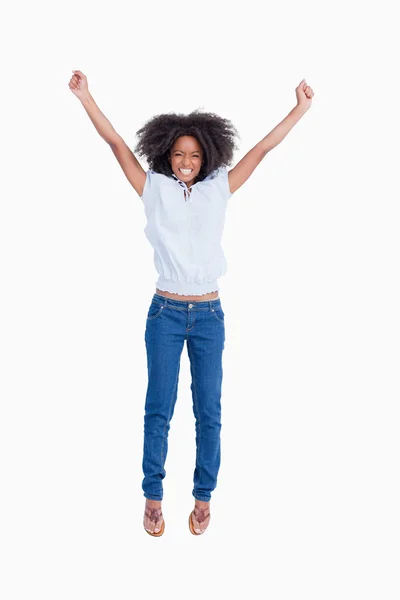 Young woman beaming while raising her arms above the head — Stock Photo, Image