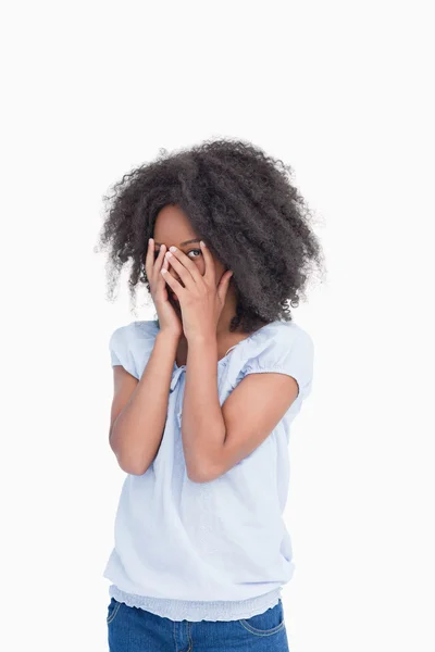 Woman trying to look at the camera through her finger placed on — Stock Photo, Image