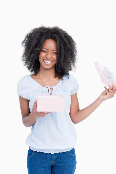Happy young woman opening a present — Stock Photo, Image