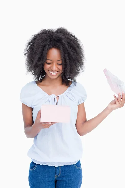 Smiling young woman looking at her birthday present — Stock Photo, Image