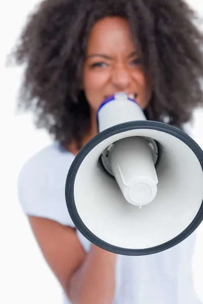 Megaphone held by a young woman shouting — Stock Photo, Image
