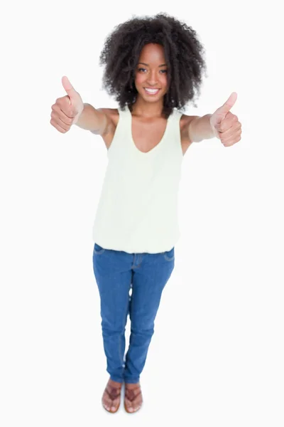 Young smiling woman placing her thumbs up in satisfaction — Stock Photo, Image