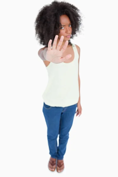 stock image Young woman standing upright while making the hand stop sign