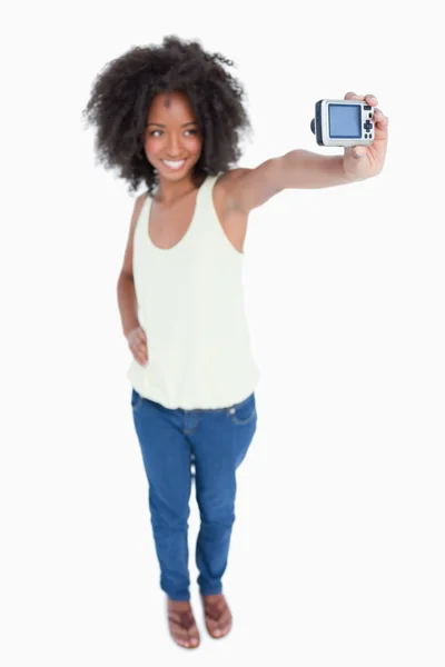 Joven mujer sonriente sosteniendo su cámara digital — Foto de Stock