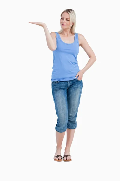Blonde woman looking at her right hand palm up — Stock Photo, Image