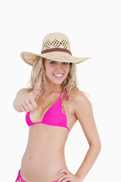 Thin teenager in beachwear showing her thumbs up — Stock Photo, Image