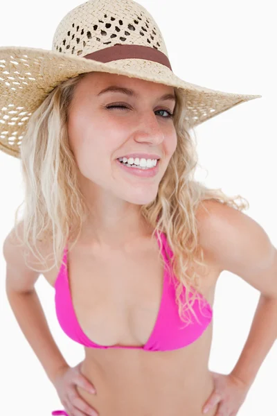 A smiling young woman blinking an eye — Stock Photo, Image