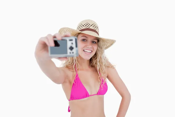 Beautiful teenage girl holding a camera while photographing hers — Stock Photo, Image