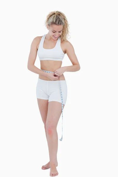 Young attractive woman measuring her waist — Stock Photo, Image