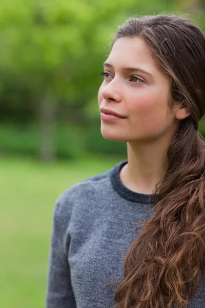 Thoughtful young girl looking towards the side — Stock Photo, Image