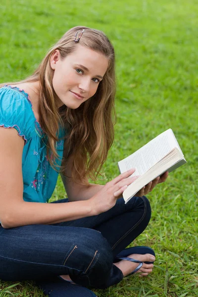 Młoda dziewczyna zrelaksowany książką siedząc w countrysi — Zdjęcie stockowe