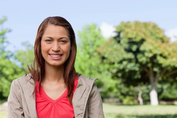 Young woman looking straight ahead with a smile on her face — Stock Photo, Image