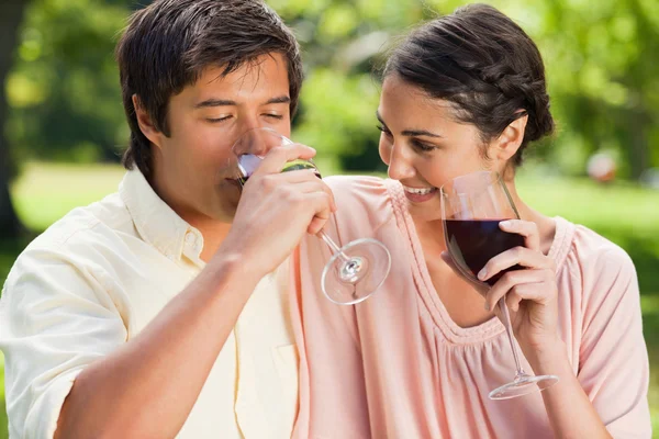 Homem bebendo vinho enquanto seu amigo olha para ele — Fotografia de Stock