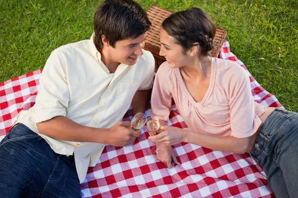 Twee vrienden glimlachend ten opzichte van elkaar tijdens een picknick — Stockfoto