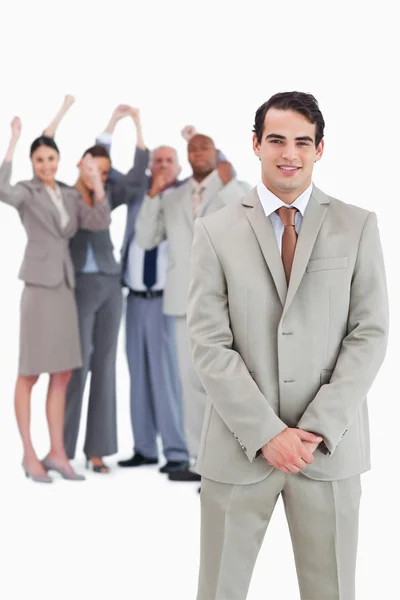 Businessman with cheering team behind him — Stock Photo, Image