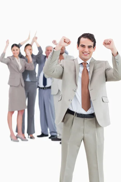 Cheering businessman with team behind him — Stock Photo, Image