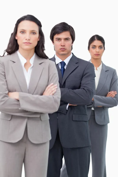 Serious salesteam standing together with arms folded — Stock Photo, Image