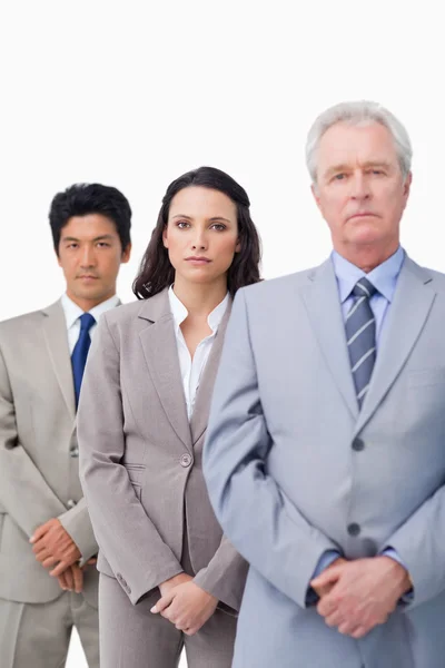 Mature salesman standing with his young employees — Stock Photo, Image