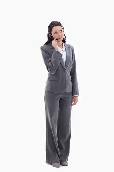 Businesswoman listening with a headset Stock Image