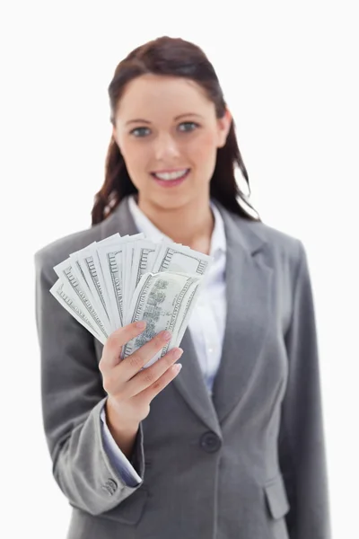 Close-up of a businesswoman smiling and holding a lot of dollar — Stock Photo, Image