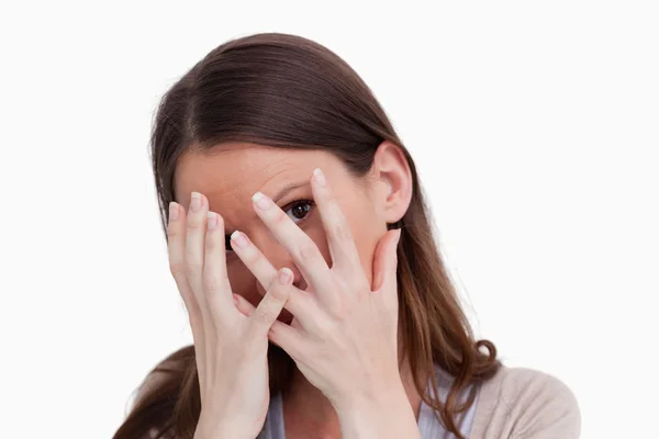 Close up of woman hiding behind her hands — Stock Photo, Image