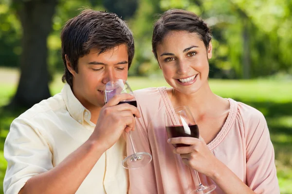 Woman smiling while her friend is drinking wine — Stock Photo, Image