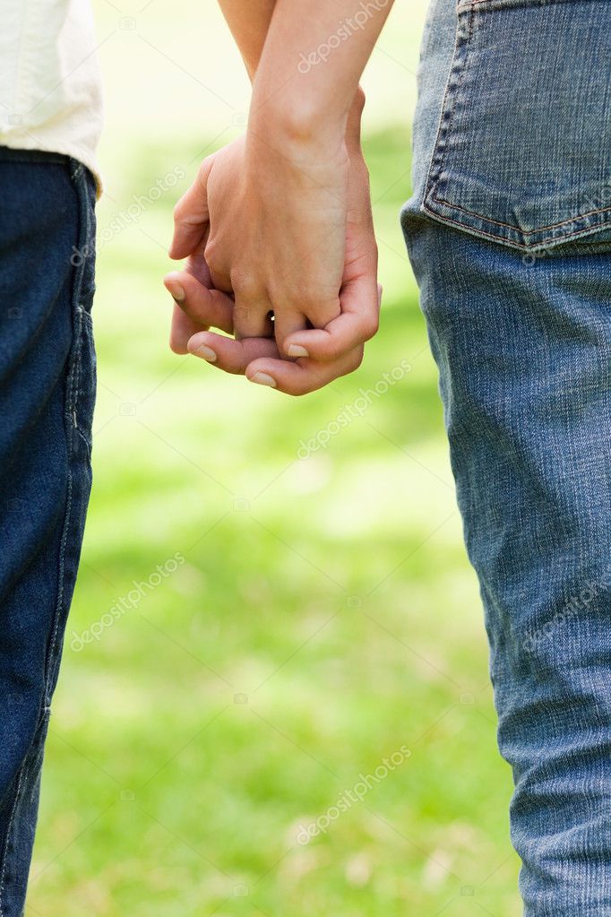 two male friends holding hands