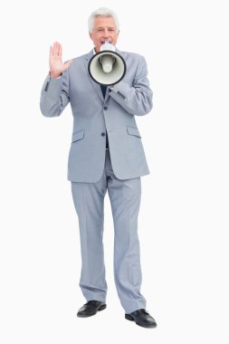 Portrait of a businessman speaking with megaphone clipart