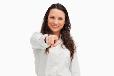 Portrait of a smiling brunette pointing clipart