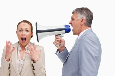 Businessman screaming after his colleague with a megaphone clipart