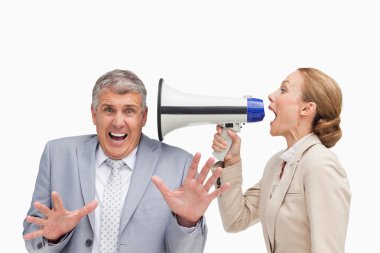 Businesswoman using a megaphone after her colleague clipart