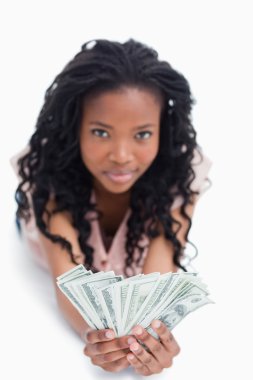 A young woman is holding American dollars in her hands clipart