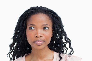 Head shot of a young woman looking away from the camera clipart