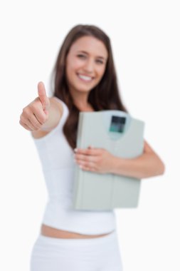 Thumbs up being placed by a brunette woman clipart