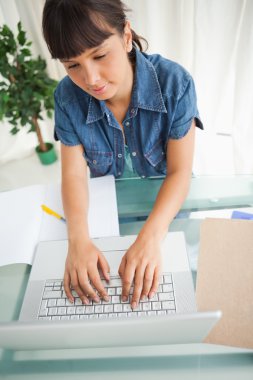 High-angle view of a student doing her homework clipart