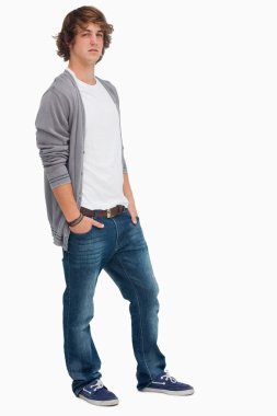 Handsome student posing hands in pockets clipart