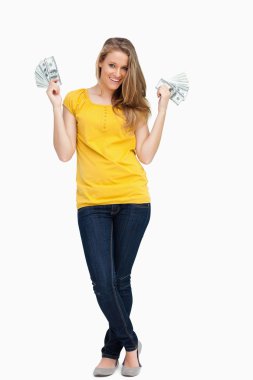 Beautiful blonde woman smiling with a lot of dollars clipart