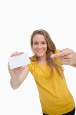 Close-up on a white card holding by a blonde woman clipart