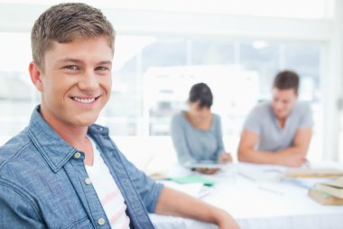 Focus shot on a male student with his friends in the background clipart