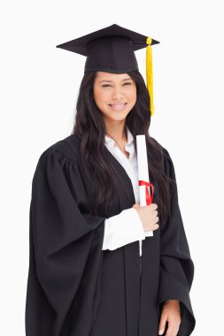 A smiling woman holding her degree as she has graduated from uni clipart