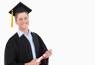 A smiling man with a degree in hand as he looks at the camera clipart