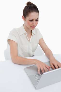 Portrait of a young businesswoman using a laptop clipart