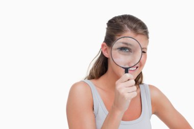 Woman looking through a magnifying glass clipart